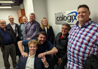 iTel Sales team gathered in front of the cologix logo in the entrance to the toronto data centre facility
