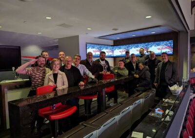 The sales team gathered in the skybox at an NBA game