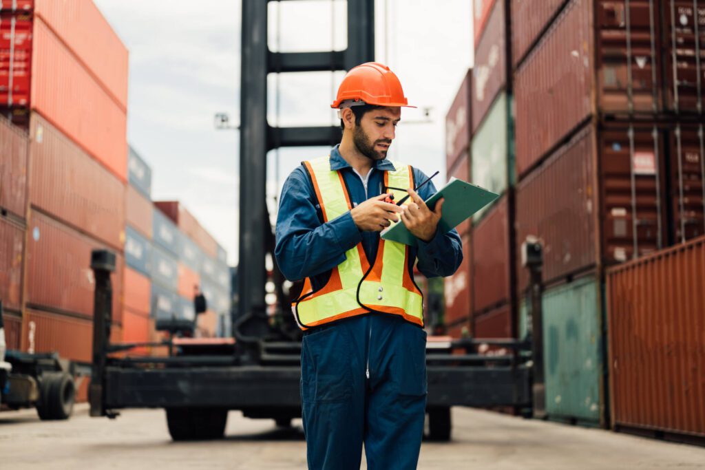 A hero image of a warehouse engineer worker working at industrial container yard