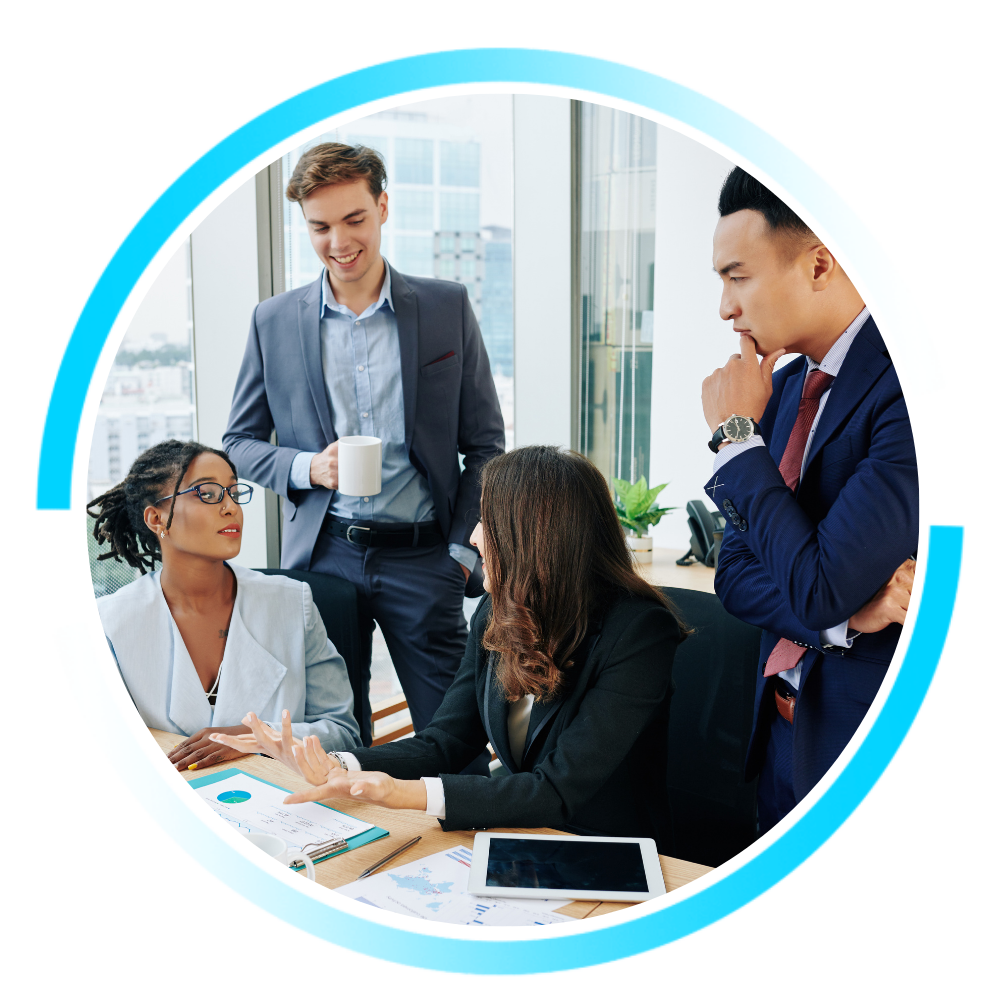 A financial team meets in a modern office, discussing reports and planning strategy around a table with documents and a tablet.